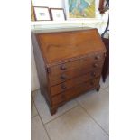 A 19th century oak bureau with a fitted interior over four long drawers - Height 109cm x 96cm x