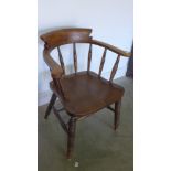 A late Victorian ash and elm smokers bow armchair