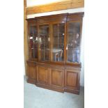 A good 20th century mahogany breakfront bookcase with four glazed doors above four panelled doors