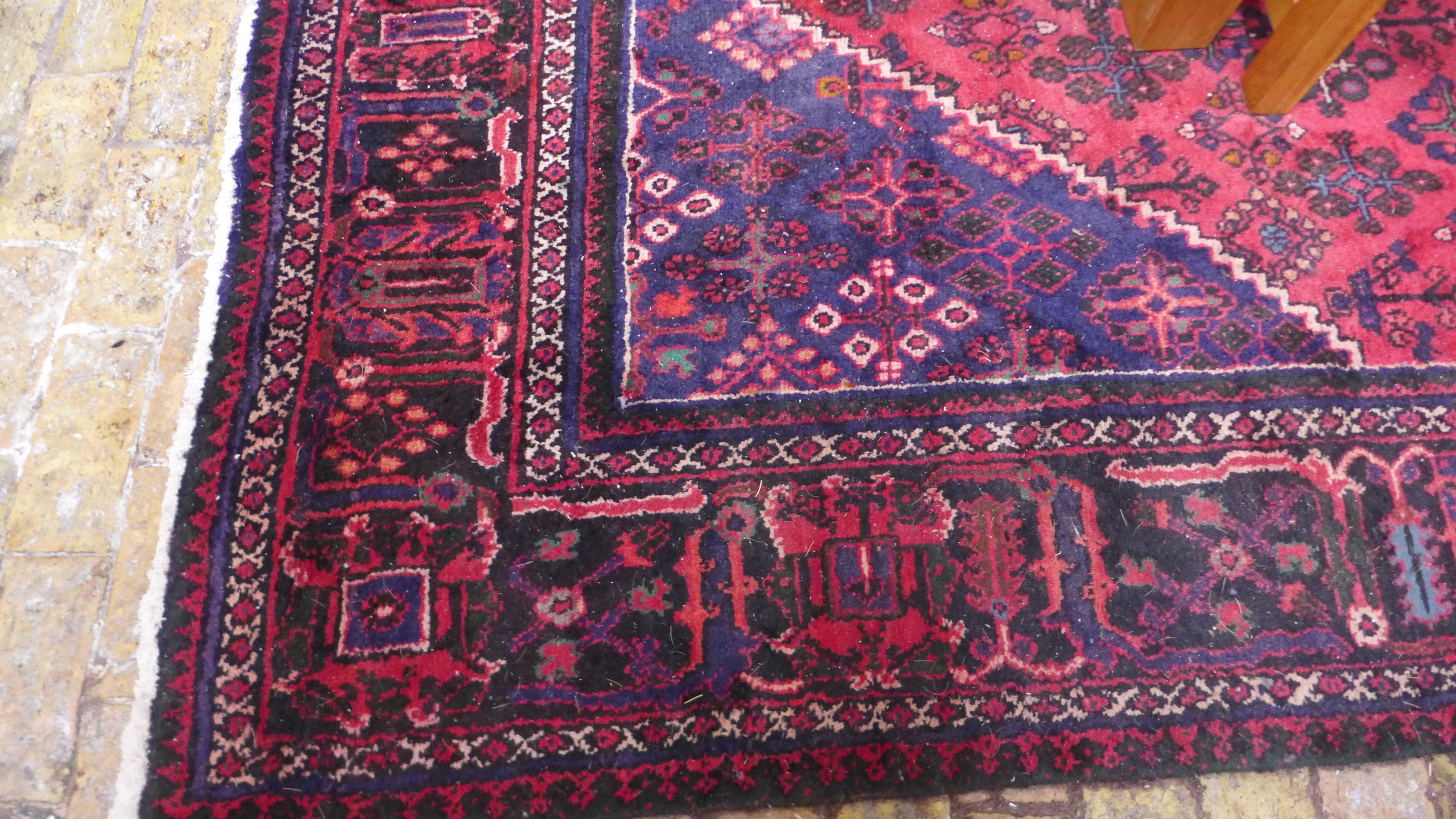 A large woolen hand knotted rug - 398cm x 240cm