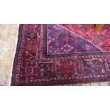 A large woolen hand knotted rug - 398cm x 240cm