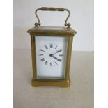 An 8 day French carriage clock with key,