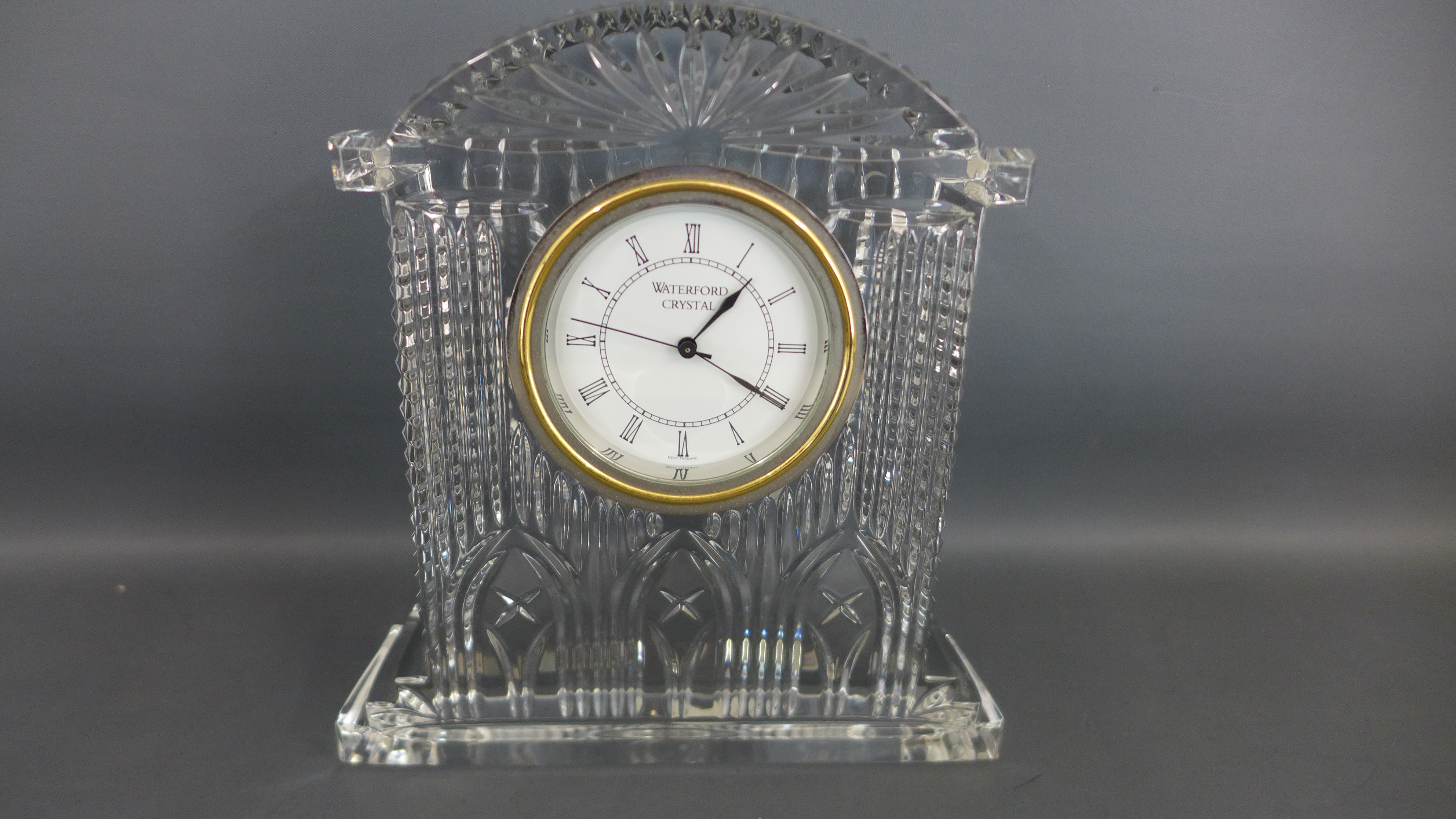 A Waterford crystal cased mantle clock with Roman numerals to white dial