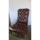 A 19th century walnut ladies chair with buttoned leather upholstery on turned legs and porcelain