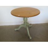 A tripod pine table with lift up top.