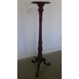 A mahogany torchere with carved column and tripod base - Height 137cm x diameter of top 30cm