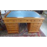 A 19th century mahogany partners desk with an inset top over nine drawers and verso three drawers