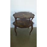 A tray top two tier etergere of oval form with painted decoration - 81cm x 50cm x 84cm