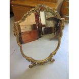 An ornate shaped gilt framed free standing toilet mirror - circa 1930's