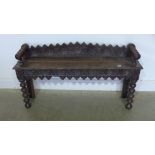 A Victorian carved oak window seat - Height 62cm x 120cm x 30cm - in need of some restoration