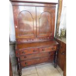 A 19th century mahogany estate/housekeeper cupboard on chest with a two door top over three small