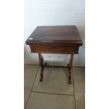 A Victorian rosewood fold over card games table/work table on twin end supports - Height 75cm x