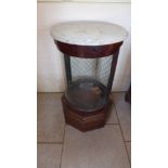 A 19th century mahogany marble top shop display cabinet of cylindrical form with a wire backed