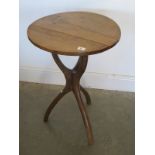 A unique early 20th century occasional table made of natural branches supporting circular pine top