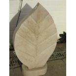 A hand carved limestone garden sculpture in leaf form - Height 80cm x Depth 13cm x Width 45cm