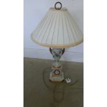 A decorative urn shaped lamp with gilt decoration