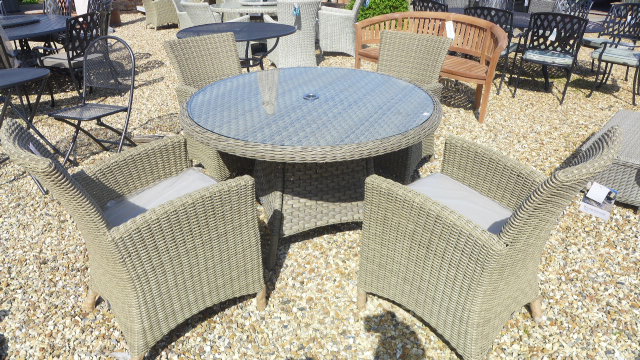 A Bramblecrest Cotswold circular table with four chairs, cushions,