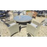 A Bramblecrest Cotswold circular table with four chairs, cushions,