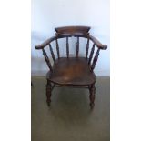 A 19th century ash and elm smokers bow armchair