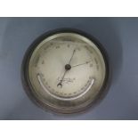 A metal cased ships aneroid barometer by J Dimmick, West Cowes Isle of Wight,