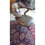 A late Victorian/Edwardian oak swivel desk chair with leather seat and pads