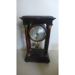 An ebonised cased Portico clock,