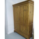 A large 19th century two door sectional pine wardrobe with hanging space to right hand side and