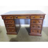 A 19th century twin pedestal nine drawer desk with a leather inset top - Height 72cm x 122cm x 67cm