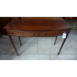 A mahogany two drawer bow fronted hall table raised on square tapering supports terminating in