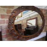 A very attractive large oval walnut mirror with pierced carved frame - circa 1940 - 92cm x 68cm