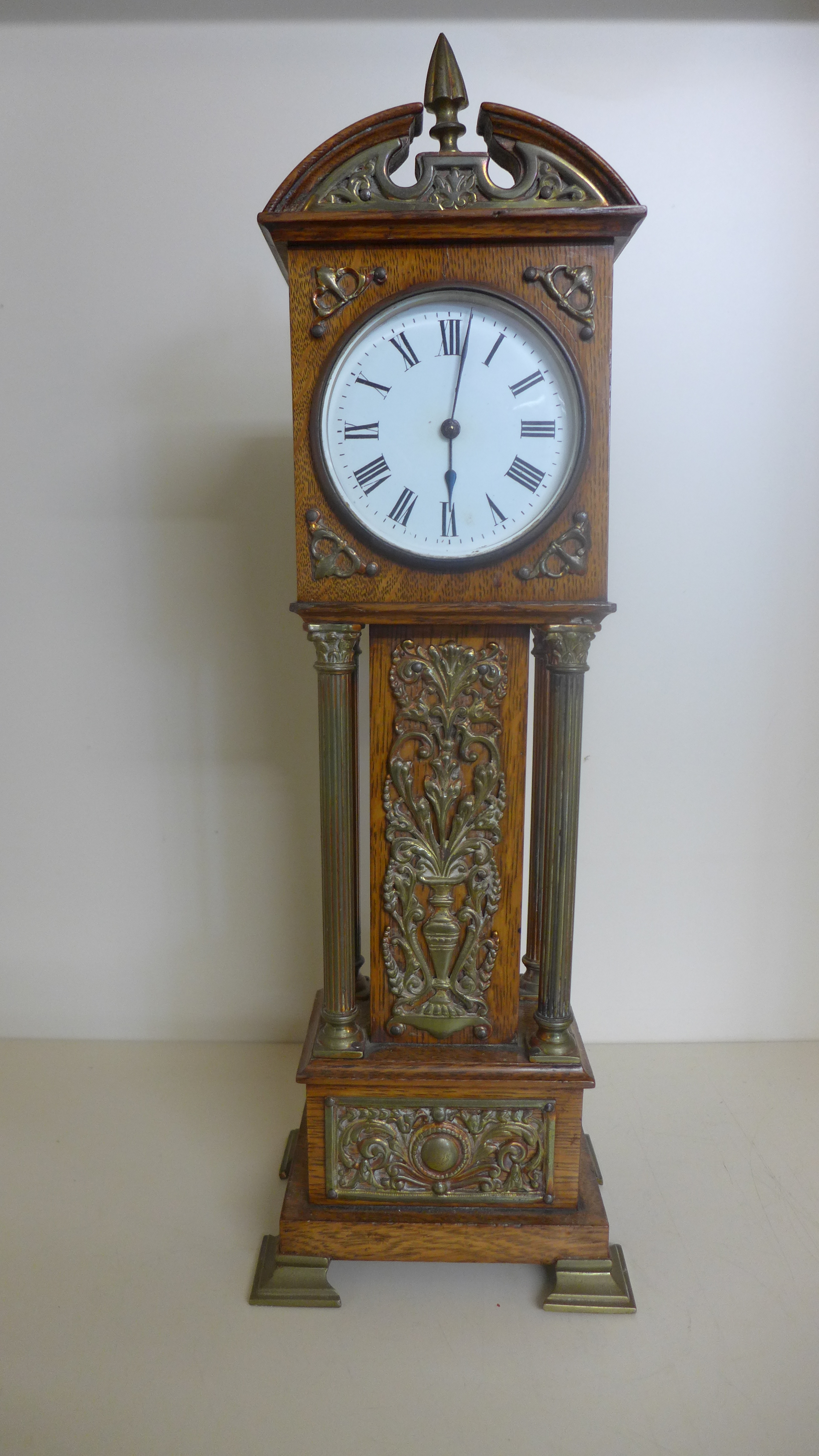 A miniature oak and ormolu mounted grandfather clock with a French movement by R and Co Paris -