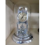 An early 20th century 400 day clock under glass dome, chrome finish,