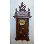 A spring driven walnut Vienna style wall clock - in working order - Height 97cm