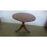A mahogany circular topped pedestal table - turned pedestal over three outswept legs terminating in