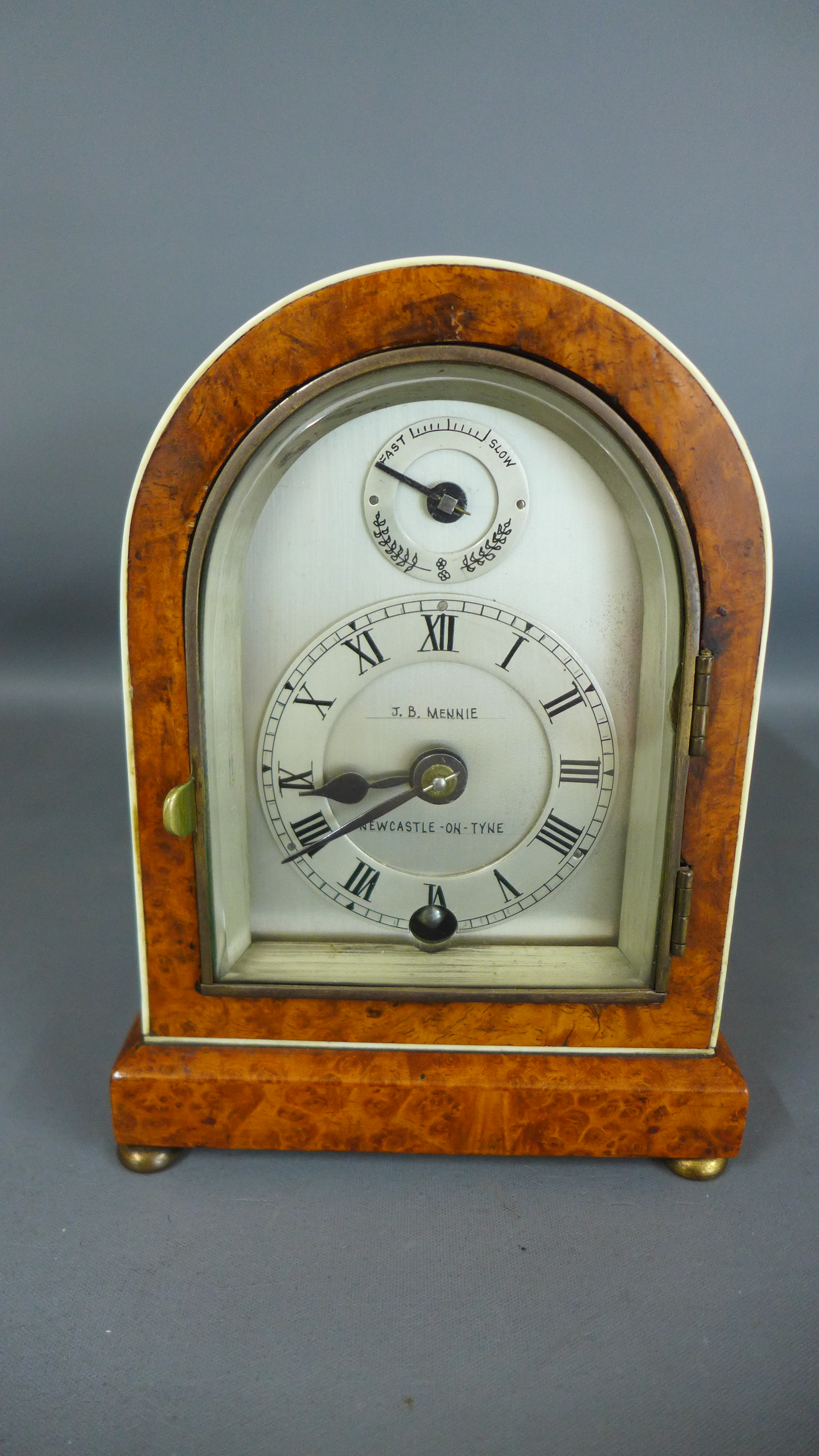 A brass walnut mantle clock of small proportions the silvered dial signed J B Mennie Newcastle on