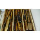 A large quantity of fifty plus wooden handled carving and turning chisels plus small wooden carvers