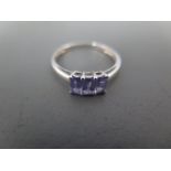 A 9ct white gold and tanzanite three stone ring size S - approx weight 1.