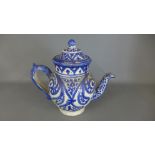 An Earthenware blue and white decorated tea pot - Height 19cm - breaks and repair to lid,