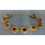 A 9ct yellow gold and ruby bracelet - approx weight 16 grams