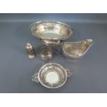 Five items of hallmarked silver including a milk jug of embossed rib design, a pepper, a pin tray,