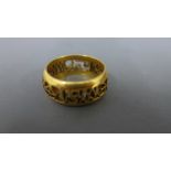 A 9ct yellow gold ring with pierced decoration to centre - approx weight 8.
