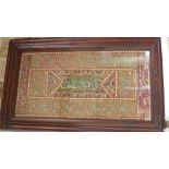 An Indian wall hanging - framed and glazed - 99cm x 60cm