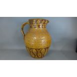 A pottery jug decorated with mythical animals, brown glazed,