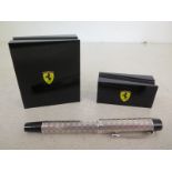 Two Ferrari pen stands together with a .