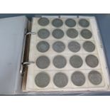 An album containing British silver coins including half crowns, florin's, two shillings,