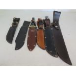 Three Bowie type knives plus spare sheaths,