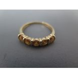 A 9ct yellow gold and five stone ring size T - approx weight 2 grams - some minor usage wear