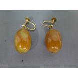 A pair of amber and gold earrings - clean and bright