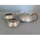 An Arts and Crafts style pewter tea service of tea pot,
