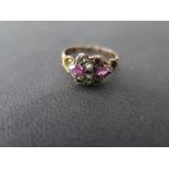 A 15ct rose gold ring set with pearls, red and green stones ring size H - approx weight 1.